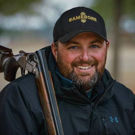 Ben Courtemarche, shotgun shooting instructor, holding an over-under shotgun